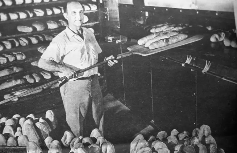 Pulling loaves from the hearth oven with a wooden peel